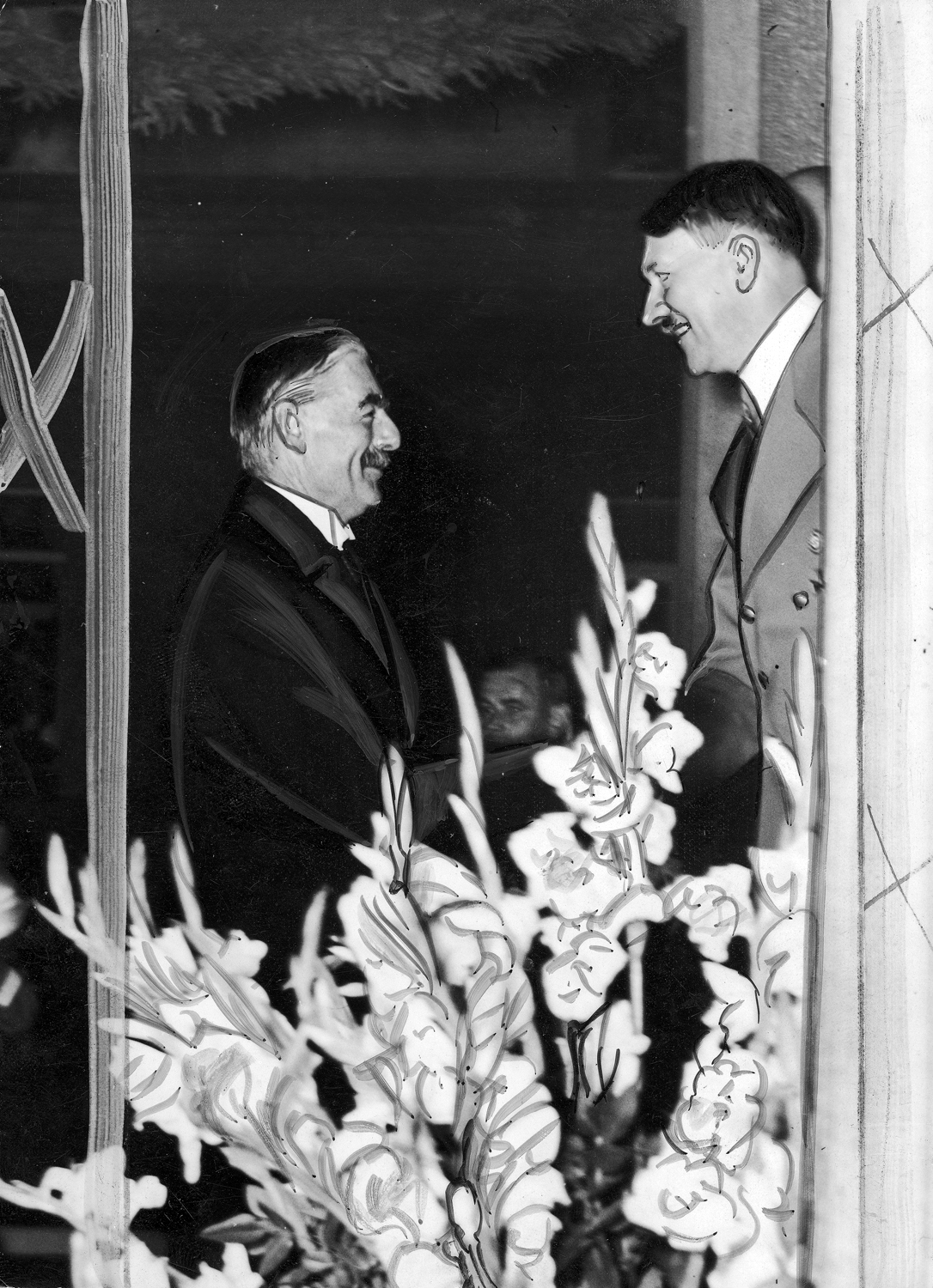 British prime minister Neville Chamberlain and Adolf Hitler shake hands during Chamberlain's visit to Germany